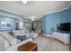 Comfortable living room featuring a sectional sofa and a large flat-screen TV at 470 Mandalay Ave # 305, Clearwater Beach, FL 33767