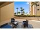 Comfortable patio furniture with view of palm trees at 470 Mandalay Ave # 305, Clearwater Beach, FL 33767