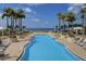 Resort-style pool with ocean views and plenty of lounge chairs at 470 Mandalay Ave # 305, Clearwater Beach, FL 33767