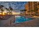 Resort-style pool with lounge chairs and sunset view at 470 Mandalay Ave # 305, Clearwater Beach, FL 33767