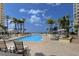 Relaxing pool area with ocean view and ample lounge chairs at 470 Mandalay Ave # 305, Clearwater Beach, FL 33767