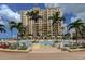 Oceanfront pool with ample lounge chairs and building view at 470 Mandalay Ave # 305, Clearwater Beach, FL 33767