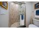 Large walk-in shower with tile surround and glass door at 470 Mandalay Ave # 305, Clearwater Beach, FL 33767