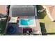 Aerial view showing home with solar panels, pool, and trampoline at 4740 Meadowsweet Ct, New Port Richey, FL 34653