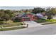 Orange house with brown garage door and landscaped yard at 4740 Meadowsweet Ct, New Port Richey, FL 34653