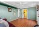 Bonus room with hardwood floors, a burgundy couch, and access to the laundry room at 5166 39Th S St, St Petersburg, FL 33711
