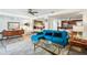 Bright living room with teal sectional sofa and mid-century modern decor at 5900 35Th N Ave, St Petersburg, FL 33710