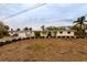 A yellow ranch home undergoing renovations with landscaping at 601 Ambassador Ln, Holmes Beach, FL 34217