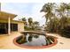 Features a kidney-shaped pool needing attention, situated beside the house at 601 Ambassador Ln, Holmes Beach, FL 34217