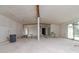 Living room during renovation, features exposed beams and large windows at 601 Ambassador Ln, Holmes Beach, FL 34217