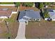 Single story gray house with a driveway and small yard at 6069 Newmark St, Spring Hill, FL 34606