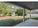 Covered patio overlooking backyard with shed and fenced yard at 6069 Newmark St, Spring Hill, FL 34606