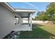 Covered patio extends from the home overlooking a fenced backyard at 6069 Newmark St, Spring Hill, FL 34606