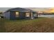 House exterior and backyard view at sunset, showing covered patio at 6069 Newmark St, Spring Hill, FL 34606