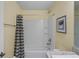 Clean bathroom with shower/tub combo and striped shower curtain at 6069 Newmark St, Spring Hill, FL 34606