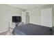 Simple bedroom with double bed, gray bedding, and built-in TV stand at 6069 Newmark St, Spring Hill, FL 34606