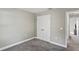 Empty bedroom with double doors and gray carpet at 6069 Newmark St, Spring Hill, FL 34606