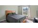Bedroom with double bed, wood headboard, and window view at 6069 Newmark St, Spring Hill, FL 34606