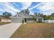 Gray house with a two-car garage and a small front porch at 6069 Newmark St, Spring Hill, FL 34606