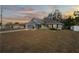 Gray house with a two-car garage, front porch, and a yard at 6069 Newmark St, Spring Hill, FL 34606