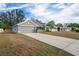 Gray house with a two-car garage and a long driveway at 6069 Newmark St, Spring Hill, FL 34606