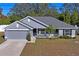 Newly built home with gray exterior, visible garage and front yard at 6069 Newmark St, Spring Hill, FL 34606
