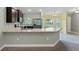 Modern kitchen with breakfast bar and stainless steel appliances at 6069 Newmark St, Spring Hill, FL 34606