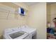 Laundry room with washer, dryer, and wire shelving at 6069 Newmark St, Spring Hill, FL 34606