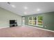 Bright living room featuring a large window and TV area at 6069 Newmark St, Spring Hill, FL 34606
