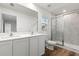 Modern bathroom with dual vanity, large mirror, and shower at 7220 Swartburg Rd, North Port, FL 34291