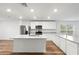 Modern kitchen with white cabinets, granite countertops and stainless steel appliances at 7220 Swartburg Rd, North Port, FL 34291