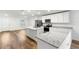 Modern kitchen with white cabinets, granite countertops and stainless steel appliances at 7220 Swartburg Rd, North Port, FL 34291