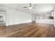 Open living room showcasing wood-look floors and kitchen access at 7220 Swartburg Rd, North Port, FL 34291