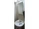 Clean bathroom with pedestal sink, medicine cabinet, and wall-mounted mirror at 8431 Edgewater Place Blvd, Tampa, FL 33615