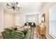 Living room featuring green sofas, wood floors, and a chandelier at 9642 Cypress Harbor Dr, Gibsonton, FL 33534