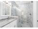 Modern bathroom with a large walk-in shower and granite countertop at 103 5Th St, Belleair Beach, FL 33786