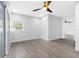 Bright bedroom with wood-look floors and ceiling fan at 103 5Th St, Belleair Beach, FL 33786