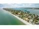 Aerial of beachfront properties and bay at 105 3Rd St, Belleair Beach, FL 33786