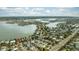 Aerial view of houses near a bay and bridge at 105 3Rd St, Belleair Beach, FL 33786