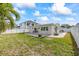 Backyard with patio, grassy lawn, and a view of neighboring home at 105 3Rd St, Belleair Beach, FL 33786
