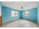 Light blue bedroom with new flooring at 105 3Rd St, Belleair Beach, FL 33786