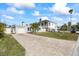 Newly renovated home with a large yard and paver driveway at 105 3Rd St, Belleair Beach, FL 33786