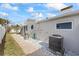 Landscaped side yard with a brick pathway leading to the back at 105 3Rd St, Belleair Beach, FL 33786