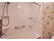 Bathroom with shower and floral-patterned walls at 1207 Eastloch Ct, Sun City Center, FL 33573