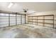 Garage with shelving and an overhead door at 1207 Eastloch Ct, Sun City Center, FL 33573