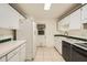 Bright kitchen with white cabinets and appliances at 1207 Eastloch Ct, Sun City Center, FL 33573