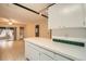 Kitchen boasts white cabinets, view to living area, and peninsula at 1207 Eastloch Ct, Sun City Center, FL 33573