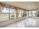 Sunroom with tiled floors and large windows at 1207 Eastloch Ct, Sun City Center, FL 33573