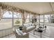 Bright sunroom with wicker furniture and view of the backyard at 1207 Eastloch Ct, Sun City Center, FL 33573