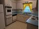 Kitchen with light wood cabinets and blue countertops at 1410 Gertrude Dr, Brandon, FL 33511